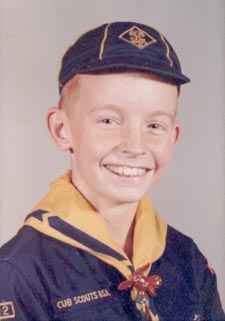 Mac, seen here in his cub scout uniform, would rather play with his sister's dolls than tend a campfire.